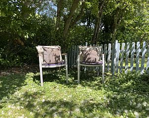 Outdoor seating at vacation home ZE120, Veere, Walcheren, surrounded by nature.