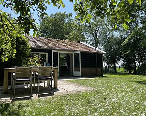 Comfortable chair in living room of vacation home ZE120, Veere, Walcheren.