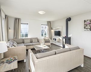 Spacious dining room in Villa 10A, a vacation home in Cadzand-bad, Zeeuws-Vlaanderen, overlooking the terrace and green surroundings.