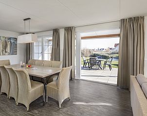 Attractive bedroom in Villa 10A, a vacation home in Cadzand-bad, Zeeuws-Vlaanderen, with garden views and modern furnishings.