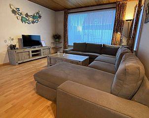 Large sitting area with TV in VZ730 Holiday home Cadzand-Bad, ideal for family gatherings.