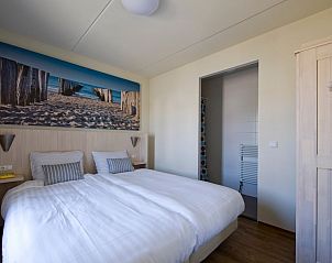 Villa 6A, a charming vacation home in Cadzand-bad, Zeeuws-Vlaanderen, with an inviting terrace and green garden in sunny Zeeland.