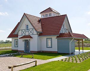 Watervilla 9A in Cadzand-bad, Zeeuws-Vlaanderen, a charming vacation home with traditional architecture and green surroundings.