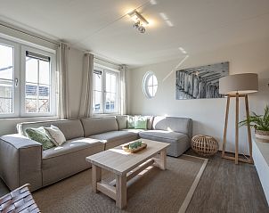 Luxury living room in Watervilla 8B Luxury, vacation home in Cadzand-bad, Zeeuws-Vlaanderen with comfortable sitting area and lots of natural light.