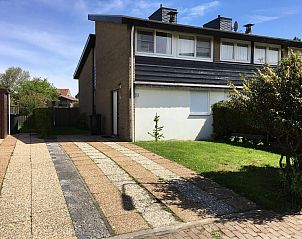 Garden with seating area in VZ924 Holiday home in Cadzand, ideal for outdoor dining in Zeeland.