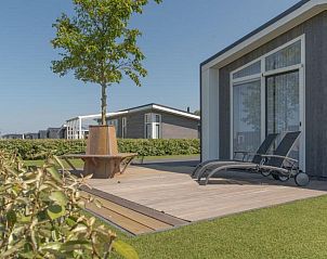 Ruim terras bij Vakantiehuis Waterresort Oosterschelde huisnr. 68, Wemeldinge, met comfortabele ligstoelen.