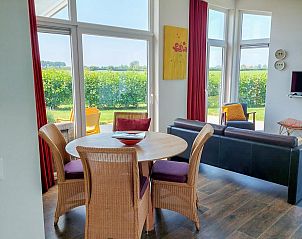 Binnenruimte van Vakantiehuis Waterresort Oosterschelde huisnr. 51, lichte eetkamer met uitzicht op tuin in Wemeldinge, Zeeland.