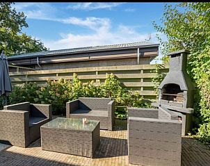 Enjoy the sunny garden with terrace and barbecue at vacation home Scheldeoord 54 in Baarland, Zuid-Beveland, Zeeland.
