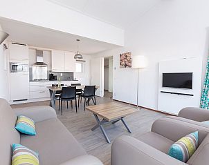 Gezellige woonkamer van Bungalow 4B in Ouddorp, Goeree-Overflakkee, met moderne keuken en comfortabele zithoek in vakantiehuis.