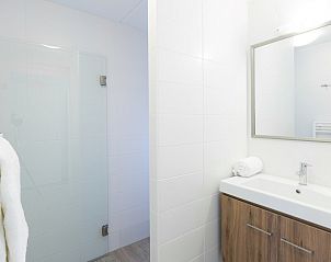 Schlafzimmer und Badezimmer im Bungalow 6C, Ouddorp, Goeree-Overflakkee, mit Blick auf die Terrasse und moderne Einrichtungen.