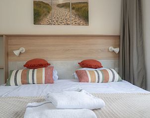 Gemtliches Zimmer im Hotelchalet Westerduin in Ouddorp mit bunten Kissen und weicher Bettwsche.