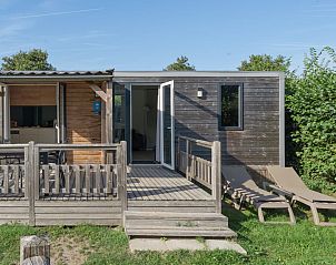Terrace of Mobil home Strandloper in Ouddorp, South Holland, with deck chairs for ultimate relaxation in nature.