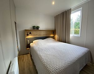 Attractive bedroom with double bed in Mobil home Strandloper, Ouddorp, for a good night's sleep.