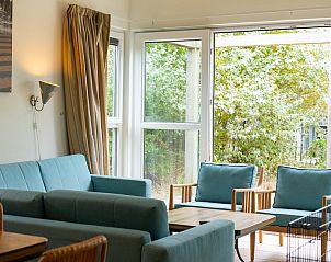 Gezellige binnenruimte van Hondenbungalow 6C in Ouddorp, Goeree-Overflakkee, Zuid-Holland met uitzicht op groene omgeving.