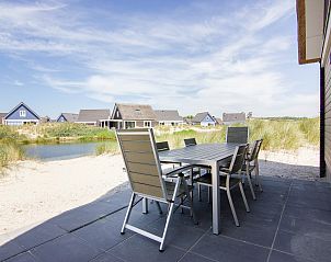 Geniet van het terras van Strand Resort Ouddorp Duin, 6-persoons villa Zandduin in Ouddorp, met uitzicht op de duinen en waterpartijen.