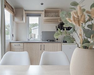 Indoor space of Mobil home the Cormorant in Ouddorp, Goeree-Overflakkee, with modern kitchen and views of nature.