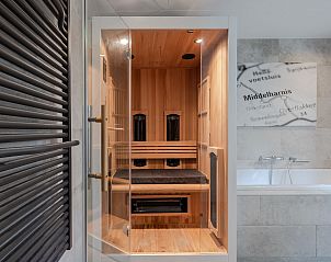 Wellness area in Bungalow Middelharnis, Ouddorp with sauna and stylish bathroom.