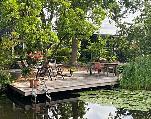 Enjoy the serene pond and green surroundings at Huisje in Hazerswoude-Dorp, a vacation home in the Green Heart of South Holland.