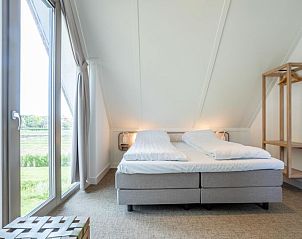 Slaapkamer in Vakantiehuis Pieper Luxe, Noordwijk, met uitzicht op de natuur aan de Noordzeekust