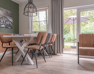 Stylish dining room in Bungalow Brouwersdam, Ouddorp, with modern furniture and garden views in Goeree-Overflakkee, South Holland.