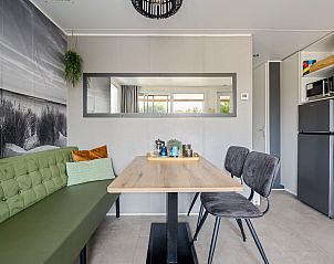 Dining area in Mobil home Beachhome in Ouddorp, perfect for cozy meals during your vacation in South Holland.