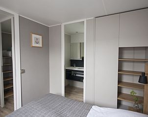 Bedroom in Mobil home Beachhome in Ouddorp, a cozy space for a good night's sleep on Goeree-Overflakkee, South Holland.