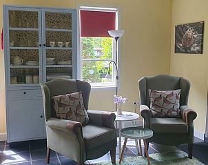 Comfortable sitting area in Holiday home in Oostvoorne, Voorne Putten, overlooking the garden.