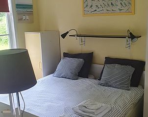 Spacious bedroom in Holiday home in Oostvoorne, perfect for a good night's sleep.