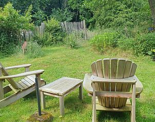 Relaxing sitting area in the garden of Holiday home in Oostvoorne, surrounded by nature.