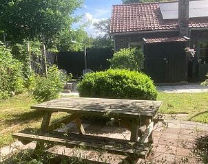 Picnic table in the garden of Holiday home in Oostvoorne, perfect for outdoor meals.
